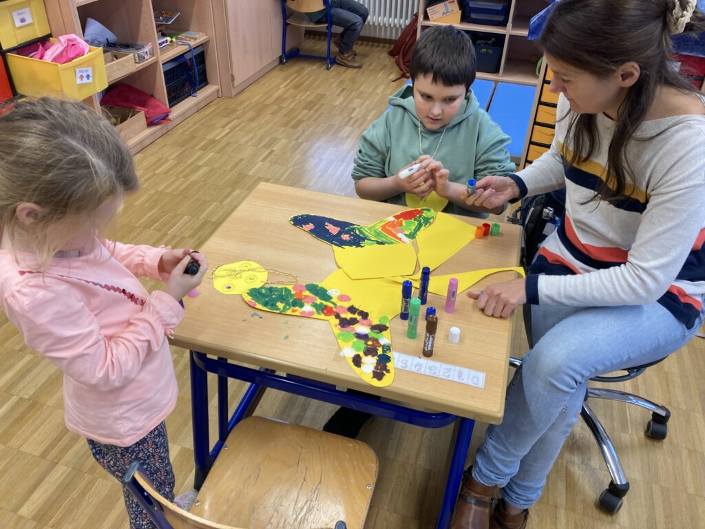 Eine Schülerin und ein Schüler gestalten Meerjungsfrauflossen 